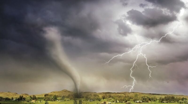 A powerful tornado and vibrant lightning striking over a rural countryside landscape.