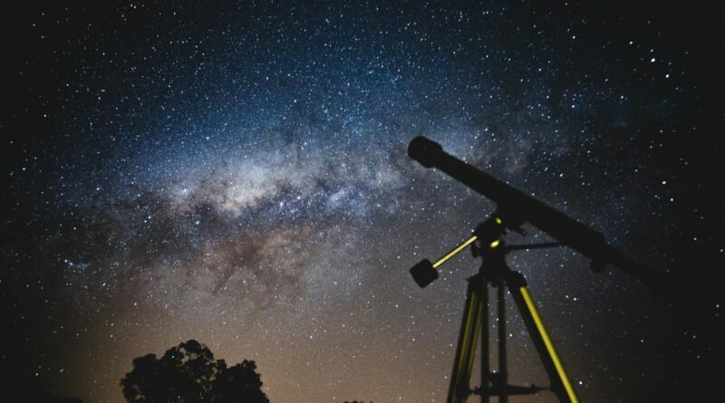 Stunning starry sky with silhouette of telescope capturing the Milky Way in Brazil.