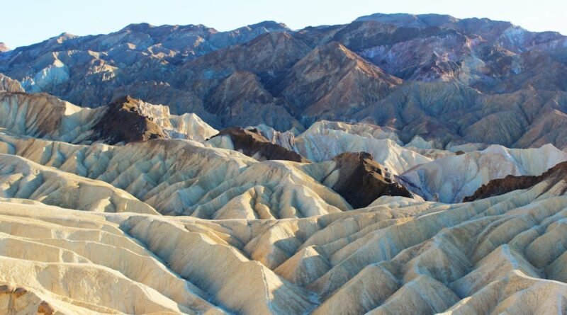 Explore the stunning geology of Zabriskie Point with its unique, rugged formations under the soft morning light.